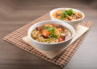 cook hot and spicy tom yum soup with mushroom and mixed vegetables in white bowl on wood background asian halal vegan menu