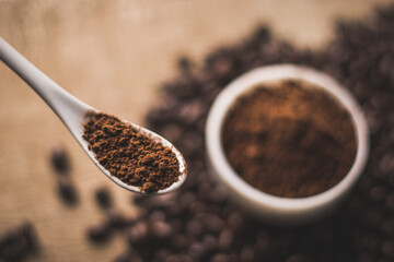 Coffee beans and powder with textured background stock image.