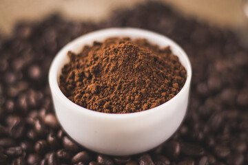 Coffee beans and powder with textured background stock image.