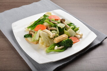 stir fried mixed vegetable and carrot in soy sauce on wood background asian halal vegan menu