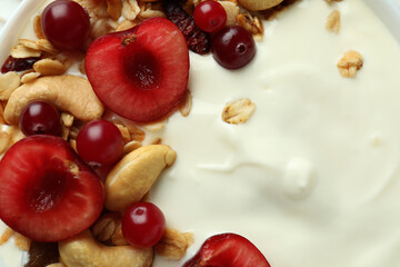 Tasty yogurt with different ingredients, close up