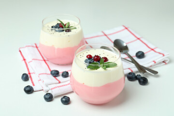 Concept of tasty breakfast with yogurt on white background