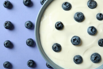 Concept of tasty breakfast with yogurt on violet background