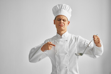 male chef with a cap on his head gesturing with the hands of professionals