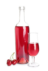 Bottle and glass of sweet cherry wine on white background