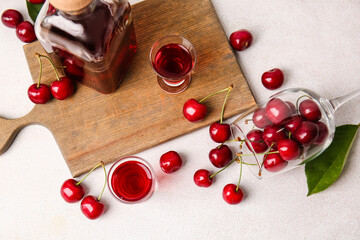 Naklejka na ściany i meble Composition with glasses of sweet cherry wine on light background