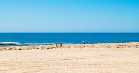 Promenade with benches on the beach at Costilla de Rota, Cadiz, Andalusia, Spain © Maria