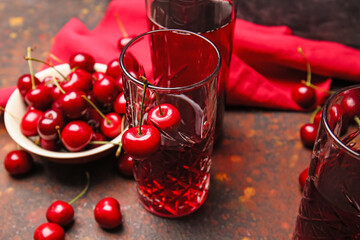 Glass of sweet cherry wine on grunge background, closeup