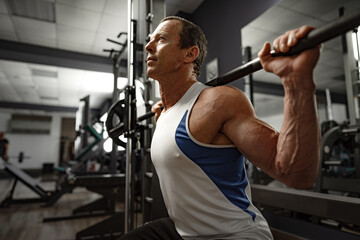 Portrait of a senior muscular man in a gym