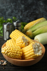 Fresh raw corn, parsley and spices on wooden table