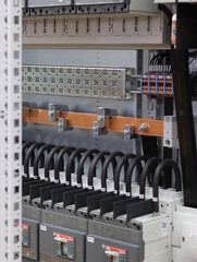 Connection of electrical protection switches using insulated copper wires in the electrical panel.