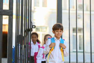 Cute little pupils near school entrance outdoors © Pixel-Shot