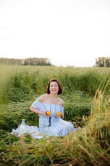 Fototapeta premium Beautiful young woman in summer in a wheat field