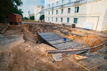 Water main repair and replacement, pit excavated to replace old pipes. Heating system pipelines reconstruction. Underground pipeline covered with precast concrete box culverts, city communications