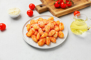 Plate with tasty gnocchi on table