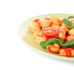 Plate with tasty gnocchi on white background