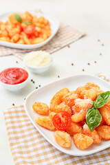 Plate with tasty gnocchi on table