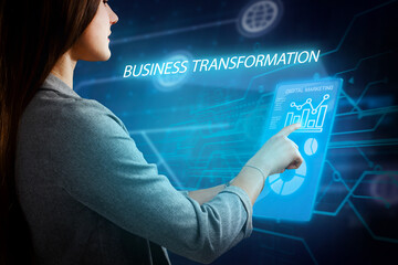 Business, Technology, Internet and network concept. Young businessman working on a virtual screen of the future and sees the inscription: Business transformation