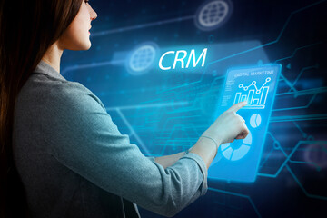 Business, Technology, Internet and network concept. Young businessman working on a virtual screen of the future and sees the inscription: CRM