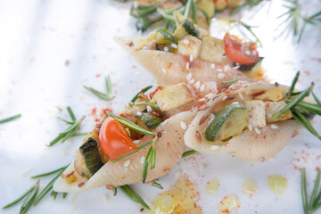 Vegan pasta shell cooking with tofu sauce and zucchini in olive oil