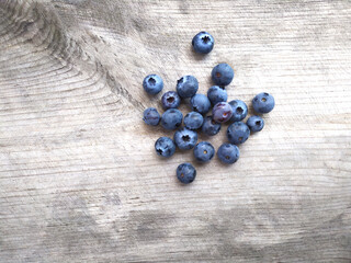 Fresh ripe blueberries on old wooden board. Berry background. Stock macro photo fresh blueberry under the sunshine, outdoors, wooden background