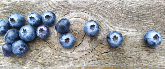 Fresh ripe blueberries on old wooden board. Berry background. Stock macro photo fresh blueberry under the sunshine, outdoors, wooden background