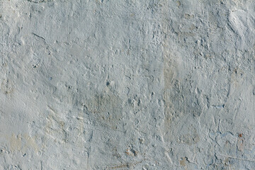 Surface of an old wall with uneven white plaster