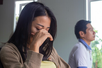 Asian women are disappointed and saddened after an argument with their husband. Asian couples are...