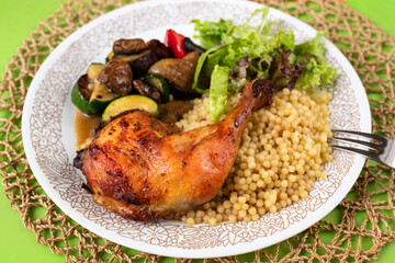 Chicken leg with fried vegetable , salad leaf and traditional pasta 
