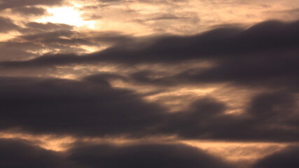 The Sun and Layers of Evening Clouds