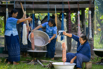 Crafts and craftsmanship. Traditional Isan Thai silk indigo weaving.Craftsmen of Thai Silk