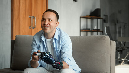 Concentrated guy with artificial high tech hand prothesis loses console game and throws joystick...