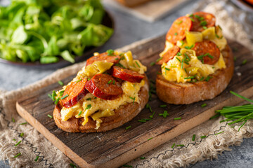 Scrambled eggs with sausage and herbs
