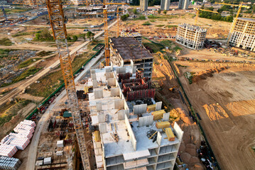 Crane during formworks on construction site. Pouring concrete into formwork. Construction the buildings and multi-storey residential homes. Tower cranes at construction and the built environment.