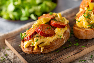 Scrambled eggs with sausage and herbs