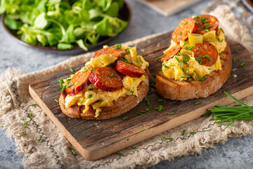 Scrambled eggs with sausage and herbs