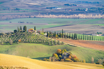 Winter view of Tuscany, Italy. Picturesque winter landscape view of Tuscany with stone houses, colorful hills, fields and vineyards in Italy