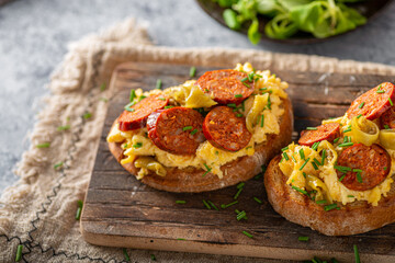 Scrambled eggs with sausage and herbs