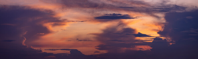 Painterly colorful cloudscape decor panorama with radiant vibrant colorful magenta, yellow and orange sunset colors. Weather conditions and climate concept. Abstract background wallpaper poster.