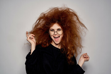cheerful woman with tousled red hair emotions glasses Studio