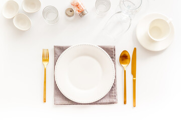 Eating utensil set - table setting for dinner with plate on napkin