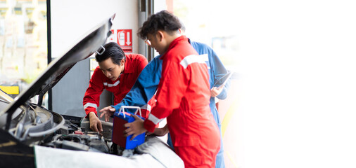 Diverse engineer team of automobile. Professional car mechanic repair service and checking car battery.