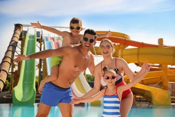 Foto op Canvas Happy family near pool in water park © New Africa