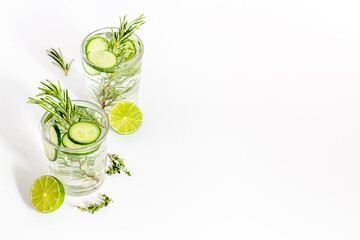Cold fresh cocktail with lemon slices cucumber and rosemary