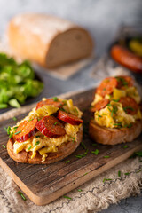Scrambled eggs with sausage and herbs
