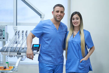 Portrait of team of male and female dentists in dental clinic