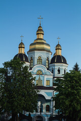 Fototapeta na wymiar Ukrainian Orthodox Church with golden domes against the background of a blue evening sky. Ukraine.