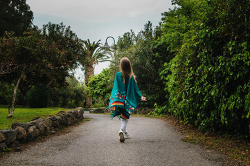 girl with her back walking along the path