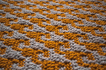 Fototapeta premium Bright tight crochet pattern. Domino pattern in the style of mosaic crochet.