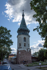 Fototapeta premium VYBORG, Leningrad REGION, RUSSIA-July, 19, 2021: the facade of the old medieval Town Hall tower and the cloudy sky on a sum